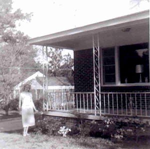 1950s - Mary Sharpe outside home